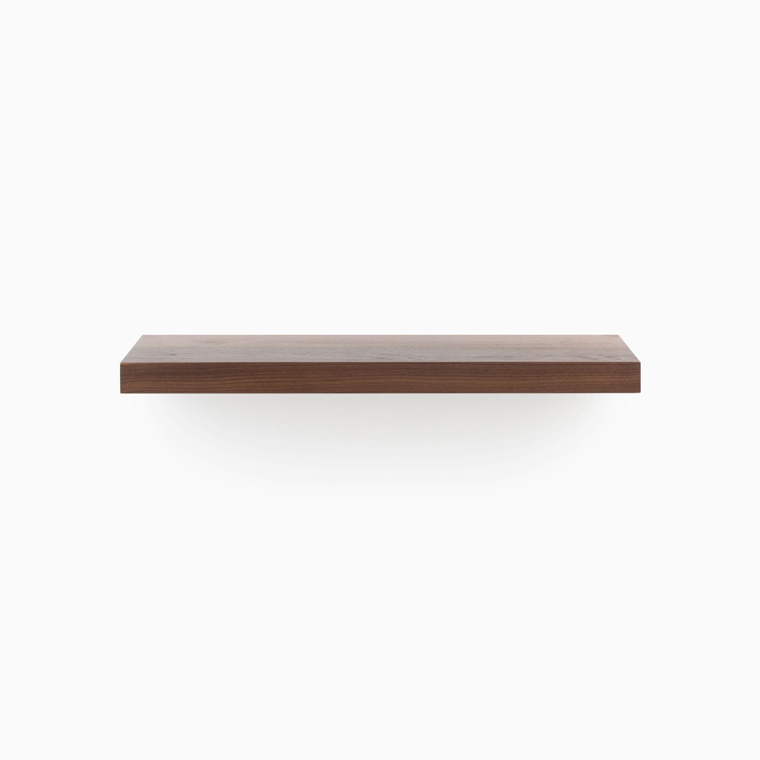 Aksel walnut floating shelf crafted from solid wood with a sleek, minimalist profile, front view