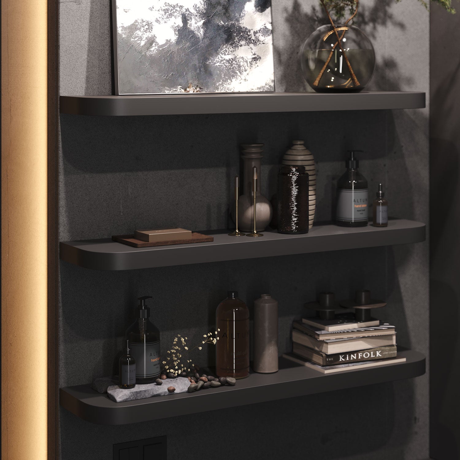 Black RADius floating shelves with rounded edges, styled with books, vases, and apothecary bottles against a dark wall. Hidden brackets for a clean, modern look.