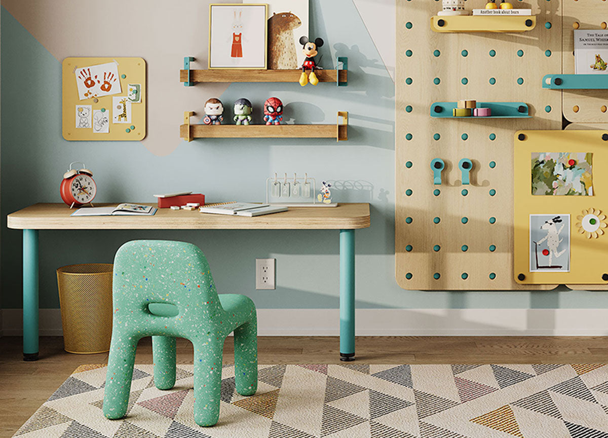 Colorful children's study area with a wood desk wall shelves pegboard storage green chair framed art and geometric rug
