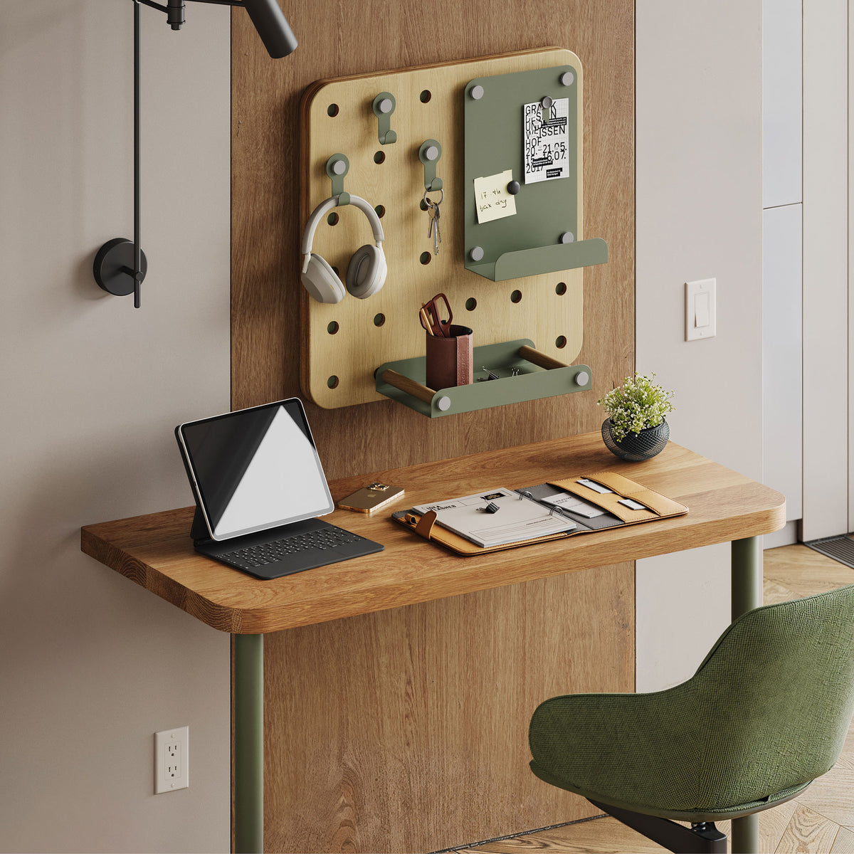 Arlo Desk (White Oak) with laptop and stationery beneath an organized pegboard workspace and green chair