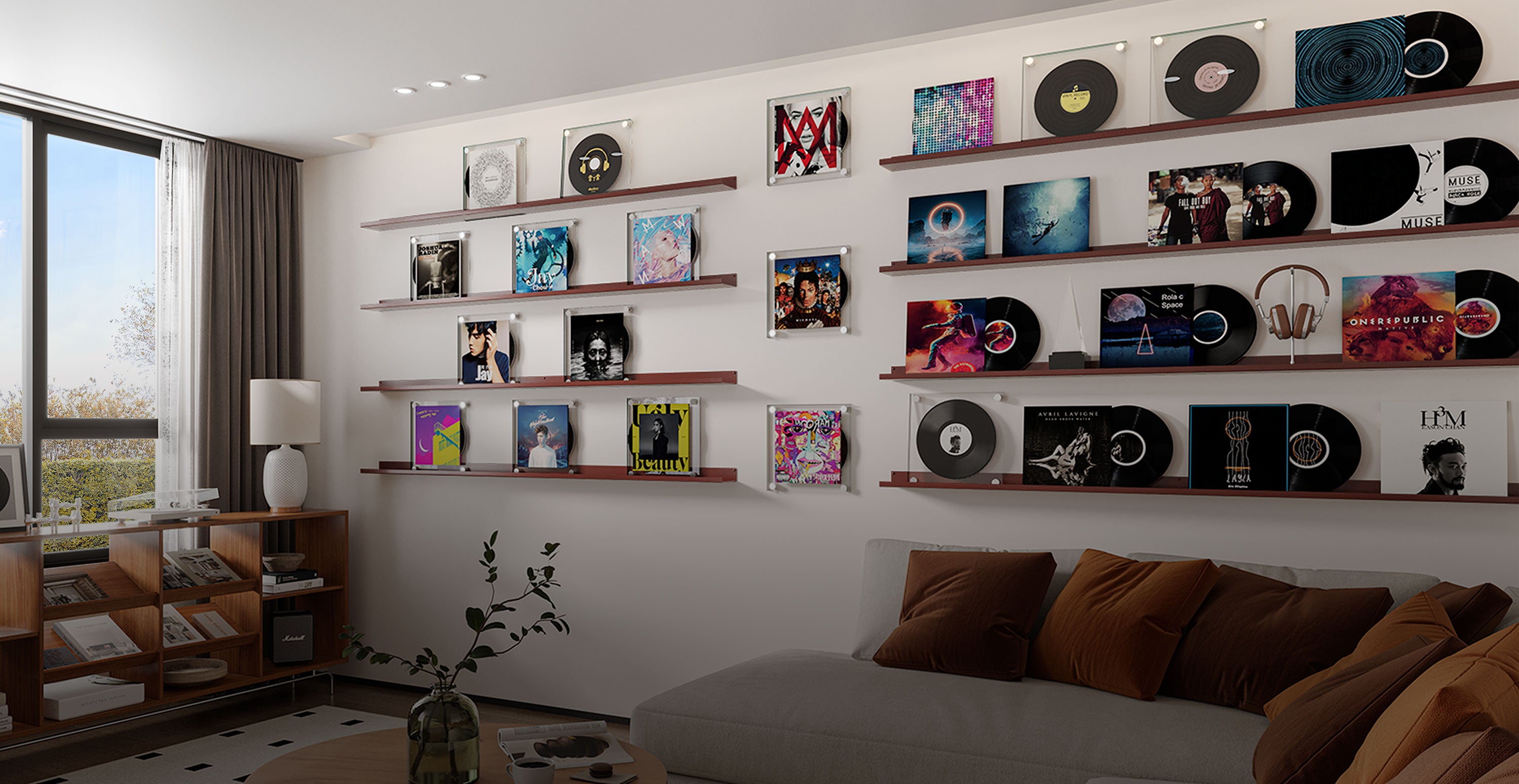 A modern living room with wall-mounted floating shelves displaying vinyl records and album covers, featuring a gray sofa with brown pillows and natural light from a window.