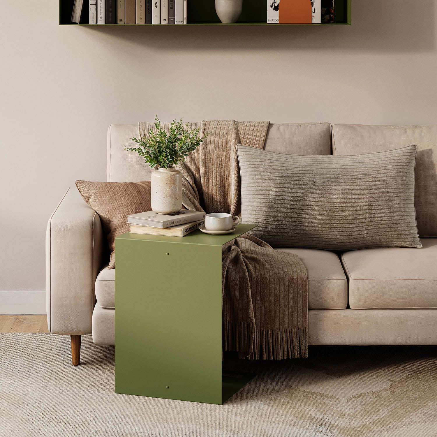 Baxter Side Table in olive green beside a neutral sofa with books coffee and a vase creating a functional living room display