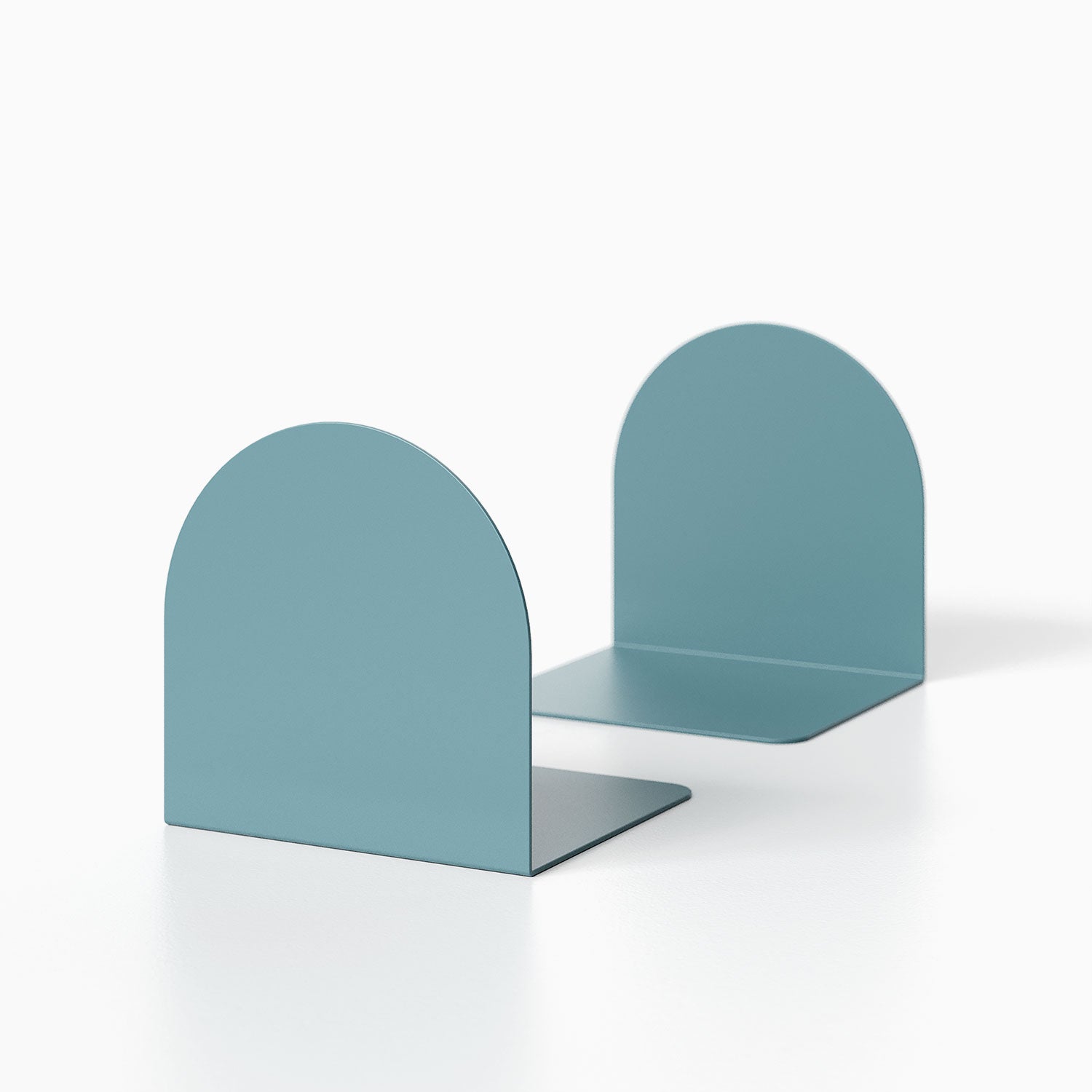 Geo Round Bookend (Set of Two) in muted blue metal with minimalist rounded design, ideal for organized wall shelves and book displays.