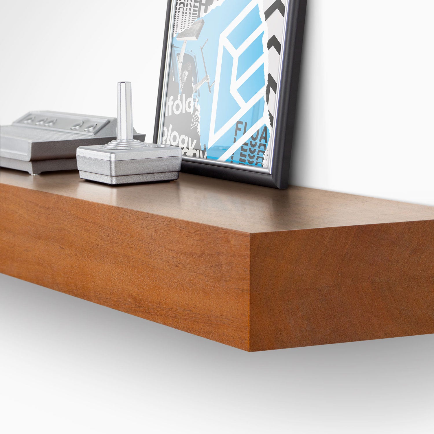 Glenn Mahogany Floating Mantel with minimalist design displaying framed art and small modern decor on a smooth wood shelf