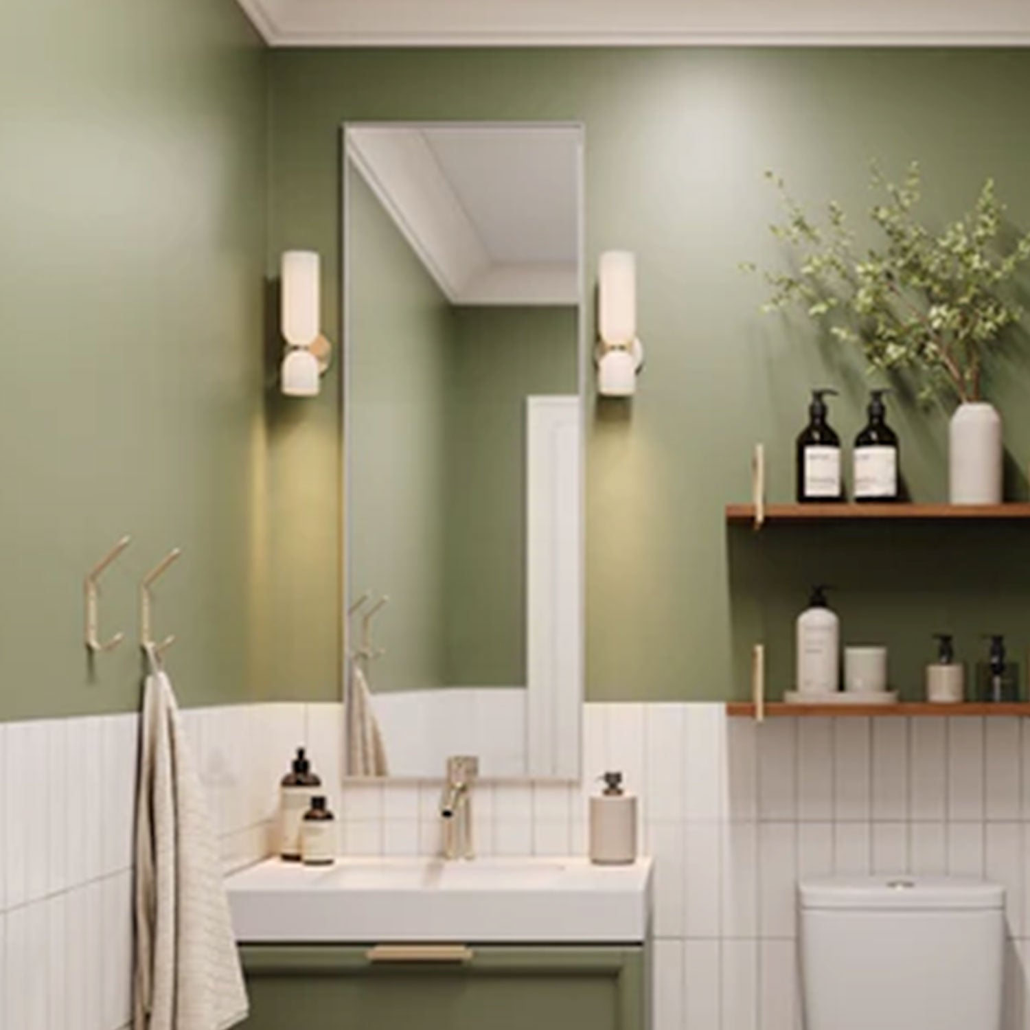 Modern bathroom with green walls, white tiled lower half, rectangular mirror, wall sconces, and Lars Floating Vanity Wall Mount Bracket supporting wooden shelves with toiletries and decor.