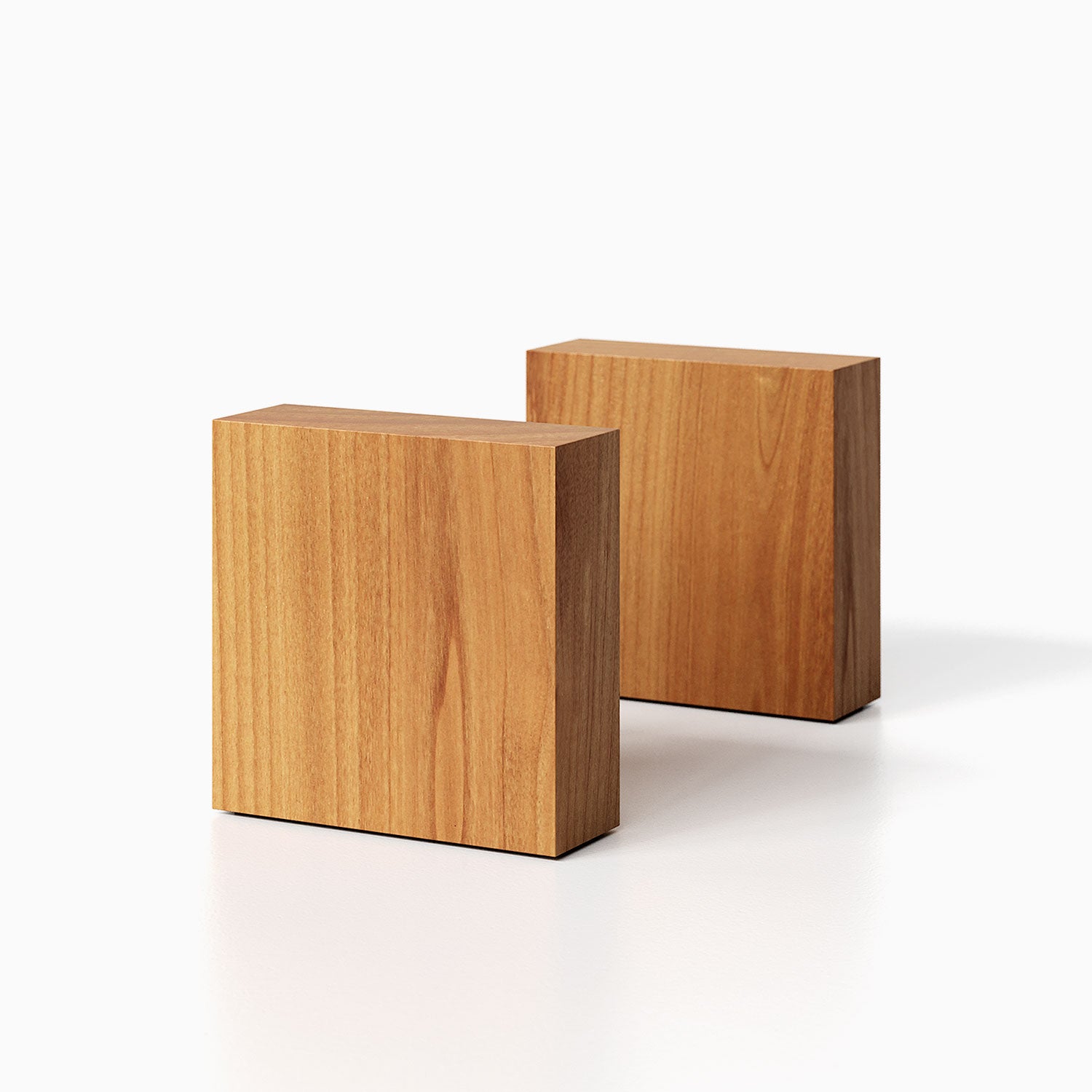 The Maggie Square Product (alder finish) pictured against a white background. Two bookends positioned in the center, one slightly off center, in front of the other.