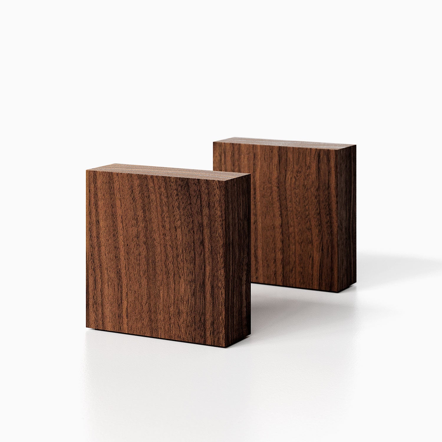 The Maggie Square Product walnut finish) pictured against a white background. Two bookends positioned in the center, one slightly off center, in front of the other.