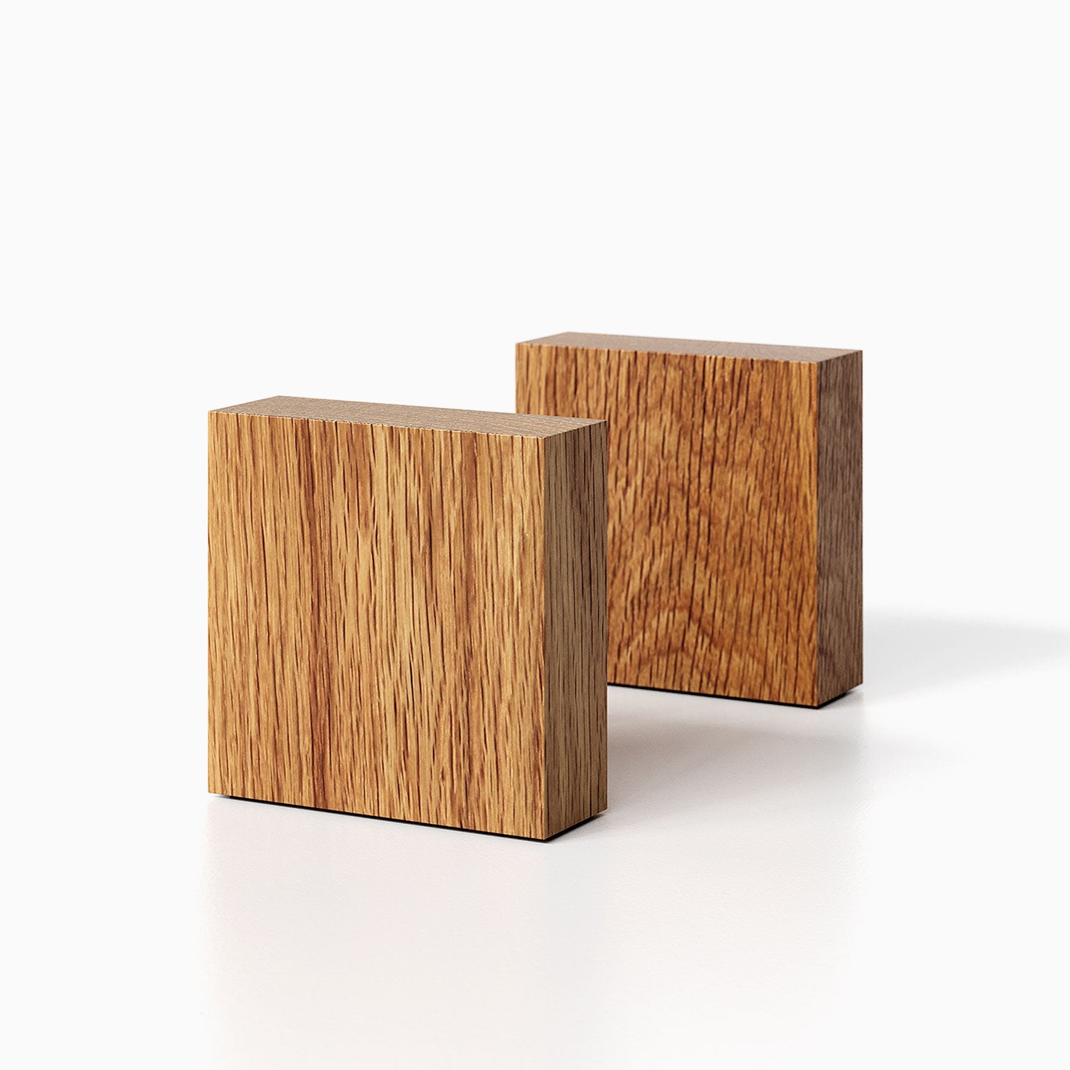 The Maggie Square Product (white oak finish) pictured against a white background. Two bookends positioned in the center, one slightly off center, in front of the other.