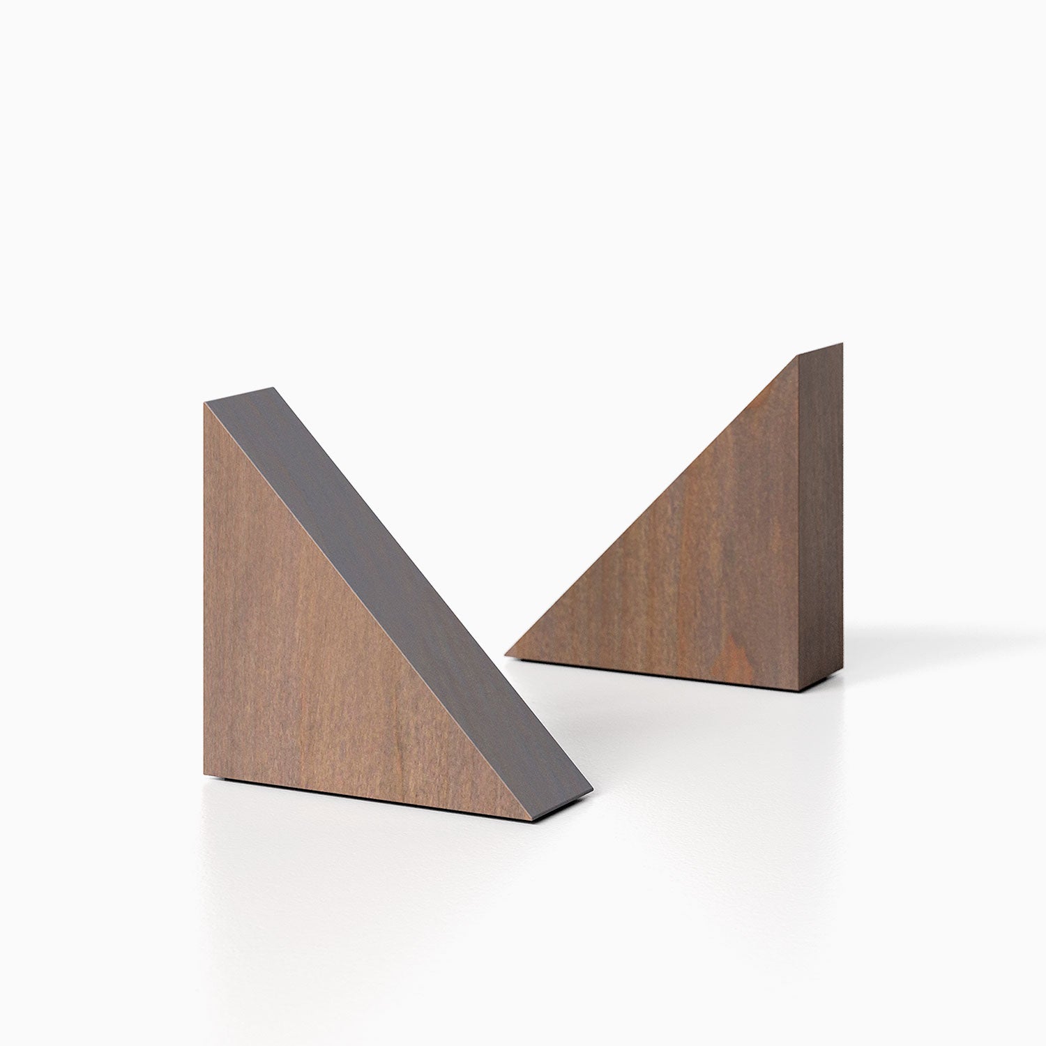 The Maggie triangle Product (hatch grey finish) pictured against a white background. Two bookends positioned in the center, one slightly off center, in front of the other.