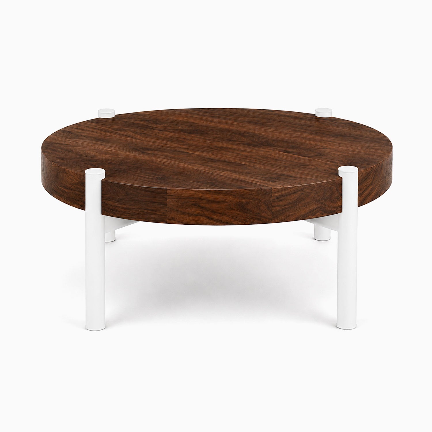 Stay Coffee Table with a round solid hardwood walnut top and minimalist white steel legs, combining durability and modern design.