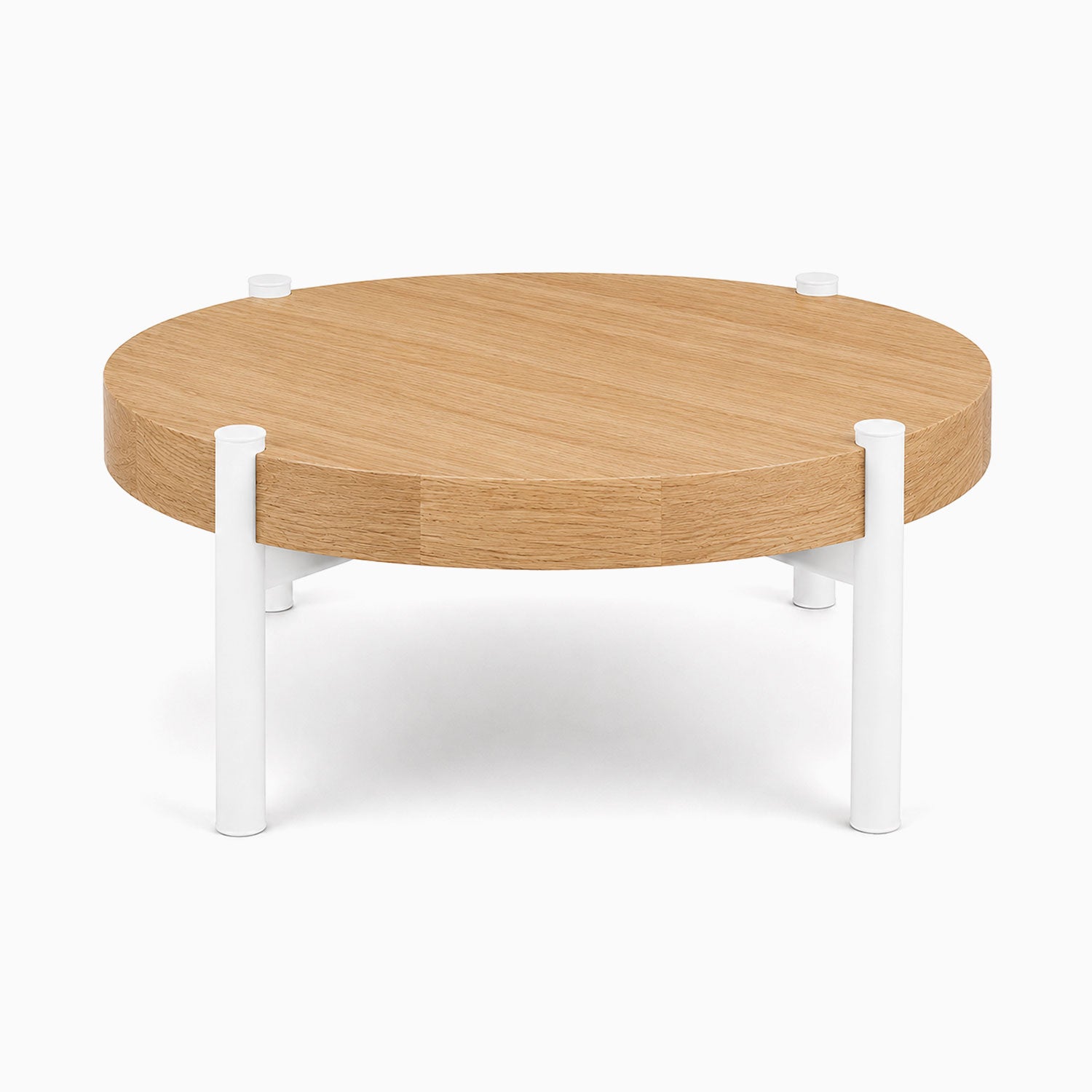Stay Coffee Table with a round solid hardwood top and minimalist white metal legs, designed for functional and stylish living spaces.
