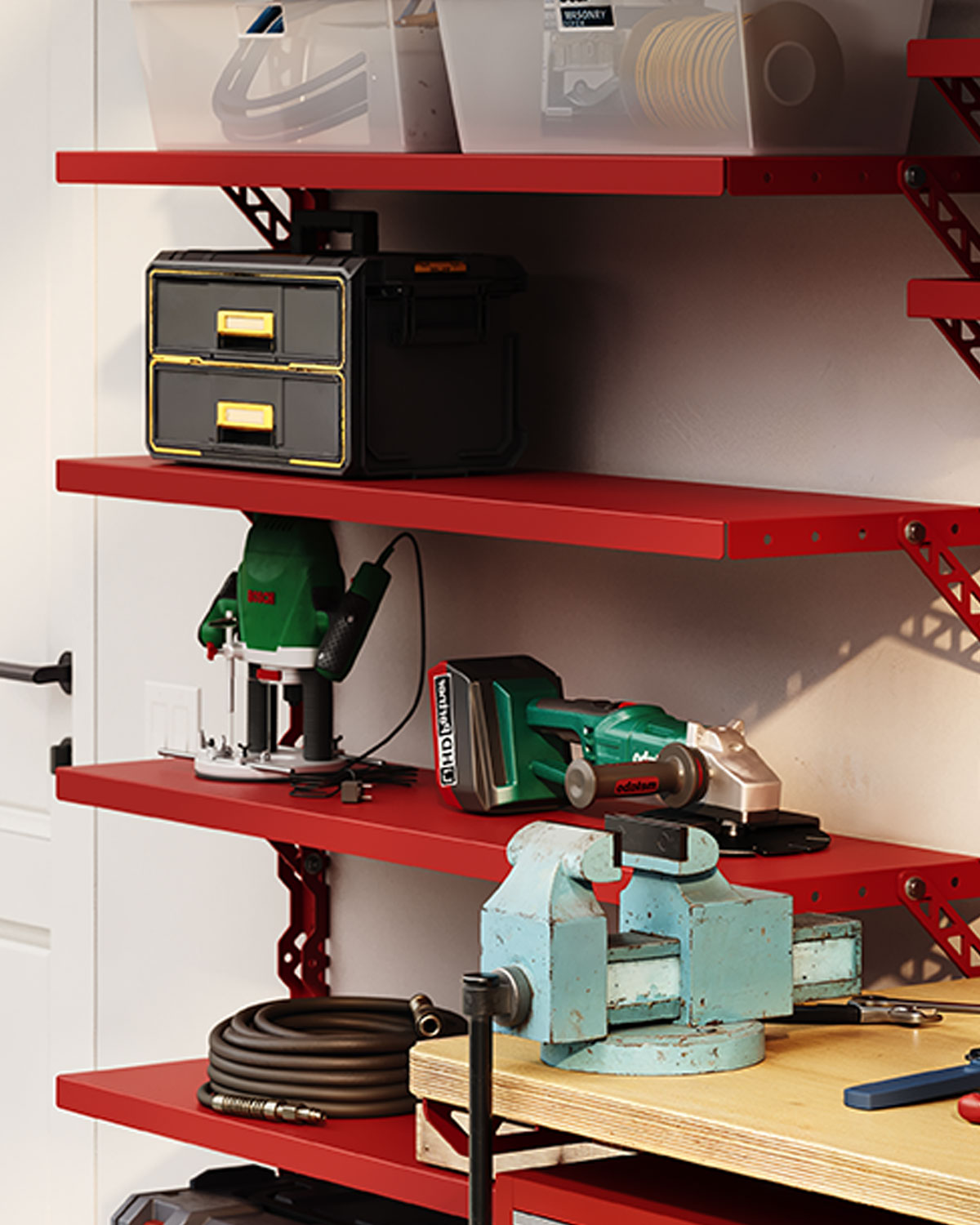 Red wall-mounted shelves holding storage bins, power tools, coiled hoses, and a blue bench vise on a wooden work surface