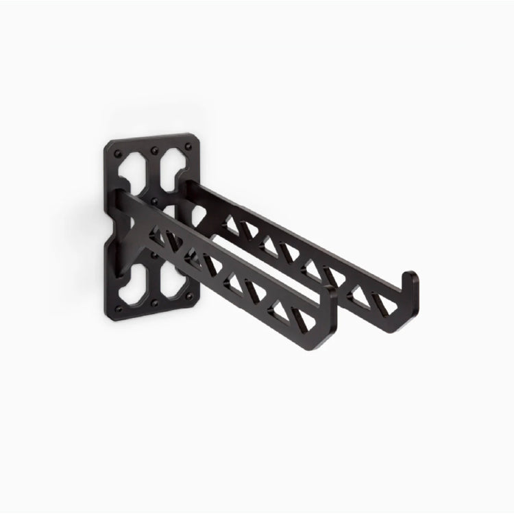 Matte black metal wall bracket with geometric cutouts designed for sturdy support of utility shelves or hanging storage solutions.