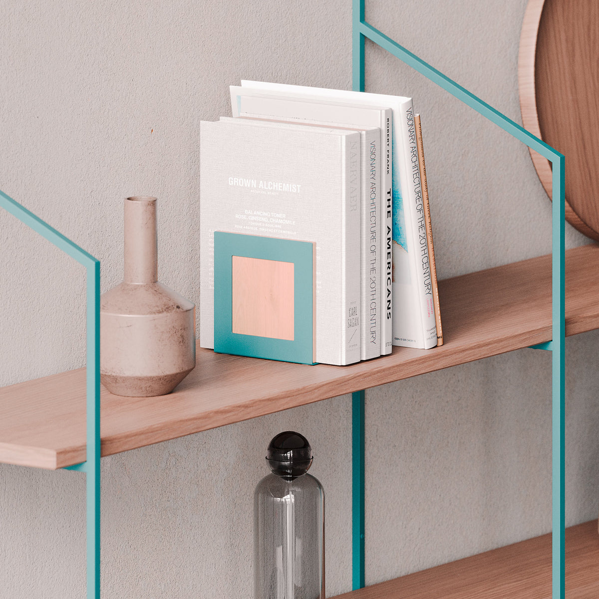 Wood wall shelves with teal metal supports, stacked books, and decorative ceramic and glass vases against a neutral wall