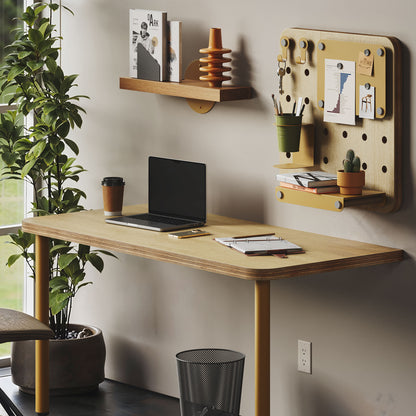 Arlo Desk (Baltic Birch) with a laptop, notebooks, coffee cup, wall shelf, and organized pegboard workspace