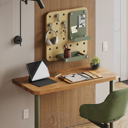 Arlo Desk (White Oak) with laptop and stationery beneath an organized pegboard workspace and green chair