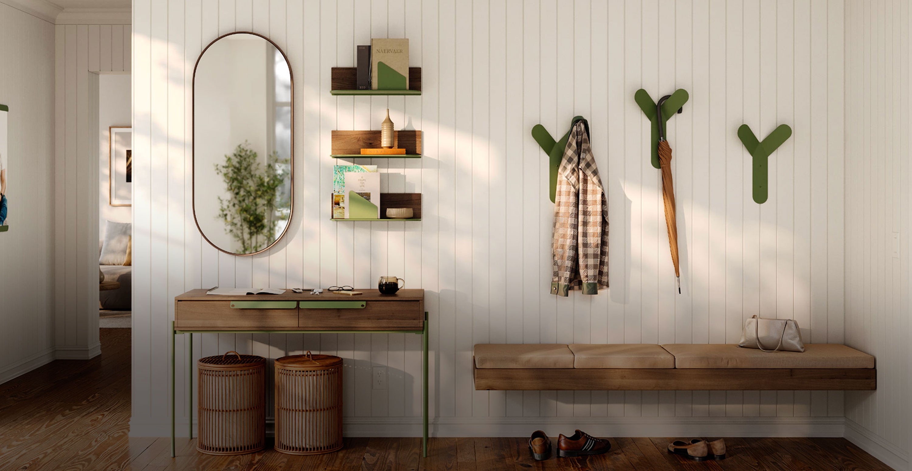 Entryway featuring minimalist wall shelves with books and decor, green wall hooks holding a coat and umbrella, a bench with cushions, and an oval mirror above a narrow wooden console table.