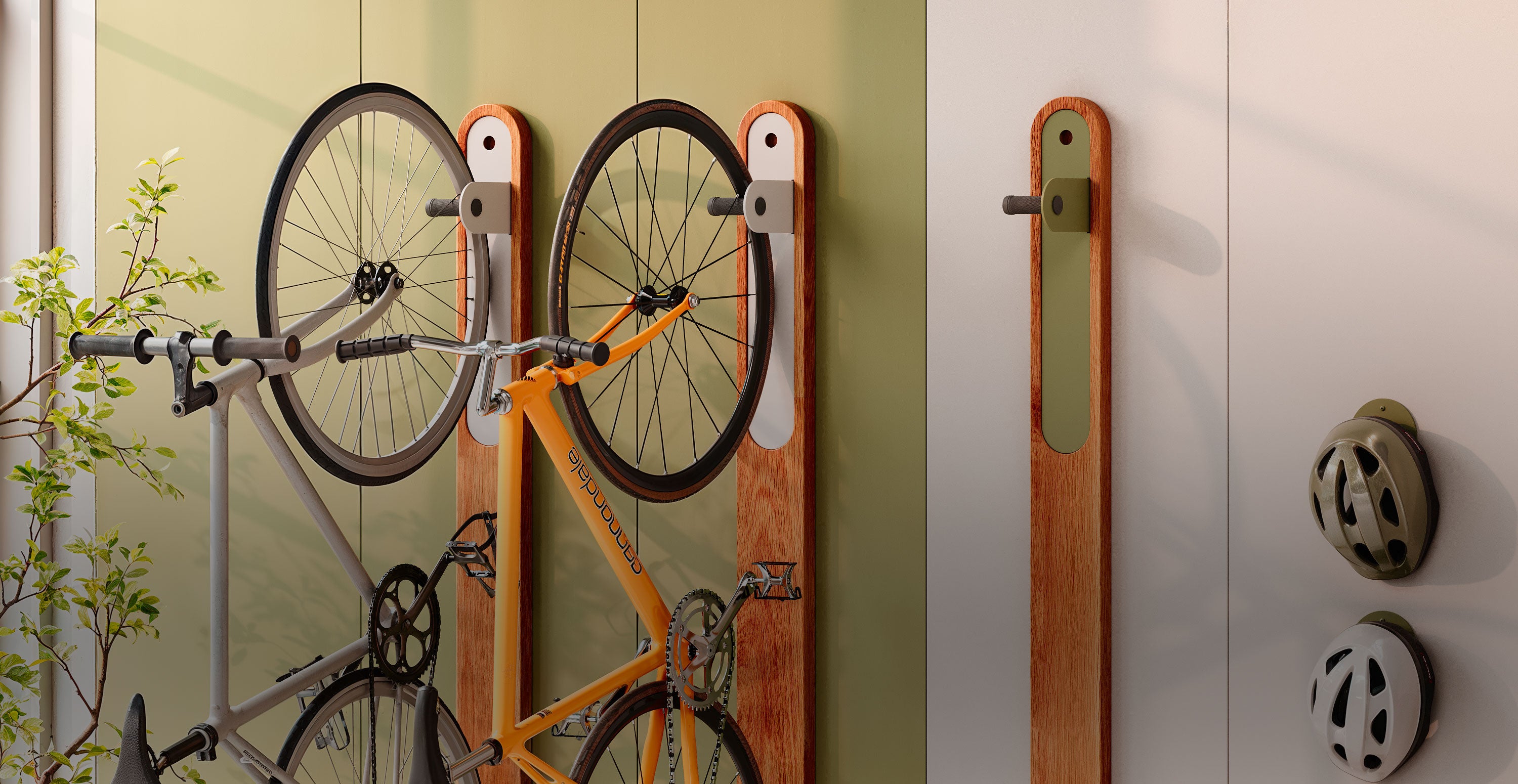 Two bicycles suspended vertically by mixed wood and metal wall hooks mounted on a pale green and white wall with two bicycle helmets hung nearby in natural light.