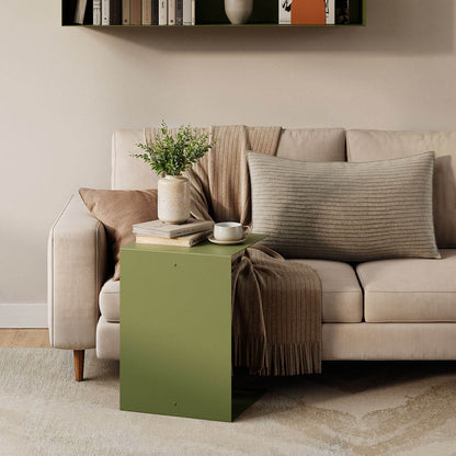Baxter Side Table in olive green beside a neutral sofa with books coffee and a vase creating a functional living room display