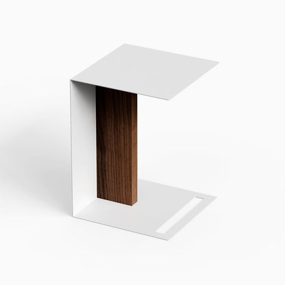 Baxter Side Table featuring a minimalist white metal frame and dark wood panel against a light background