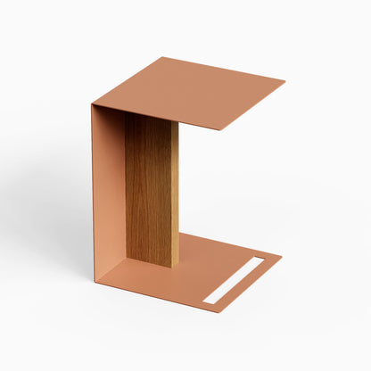 Baxter Side Table with a copper metal frame wood accent panel and open base handle for compact living spaces