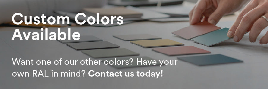 Hands selecting and arranging custom color swatches on a table with natural lighting in a creative workspace