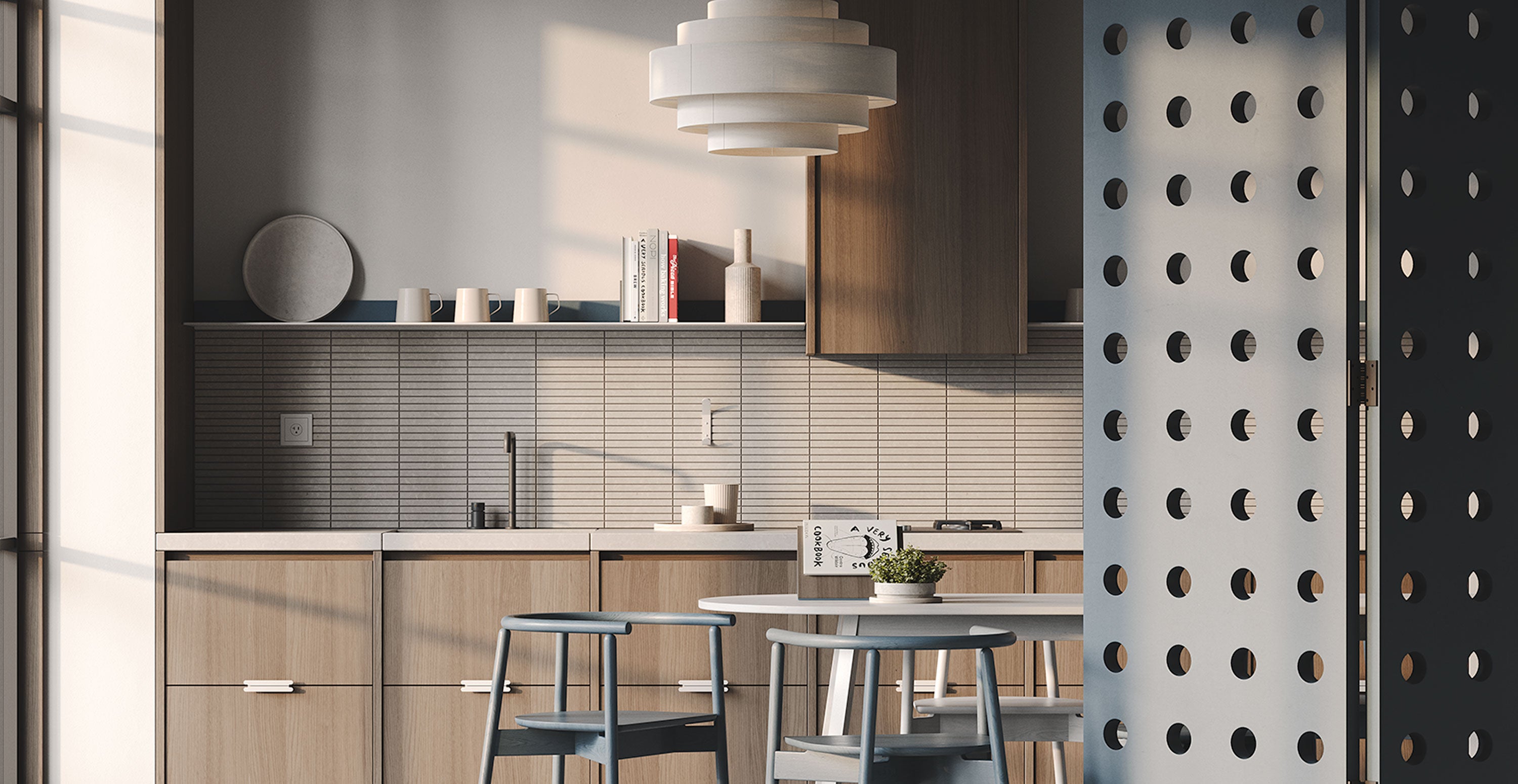 Dining nook with round wood table and chairs beside muted wood kitchen cabinetry and a wall with narrow shelf and small decor.
