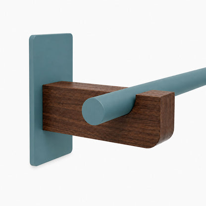 Minimalist Draper Curtain Rod System featuring a mixed-material wood and steel design with functional wall mounting bracket.