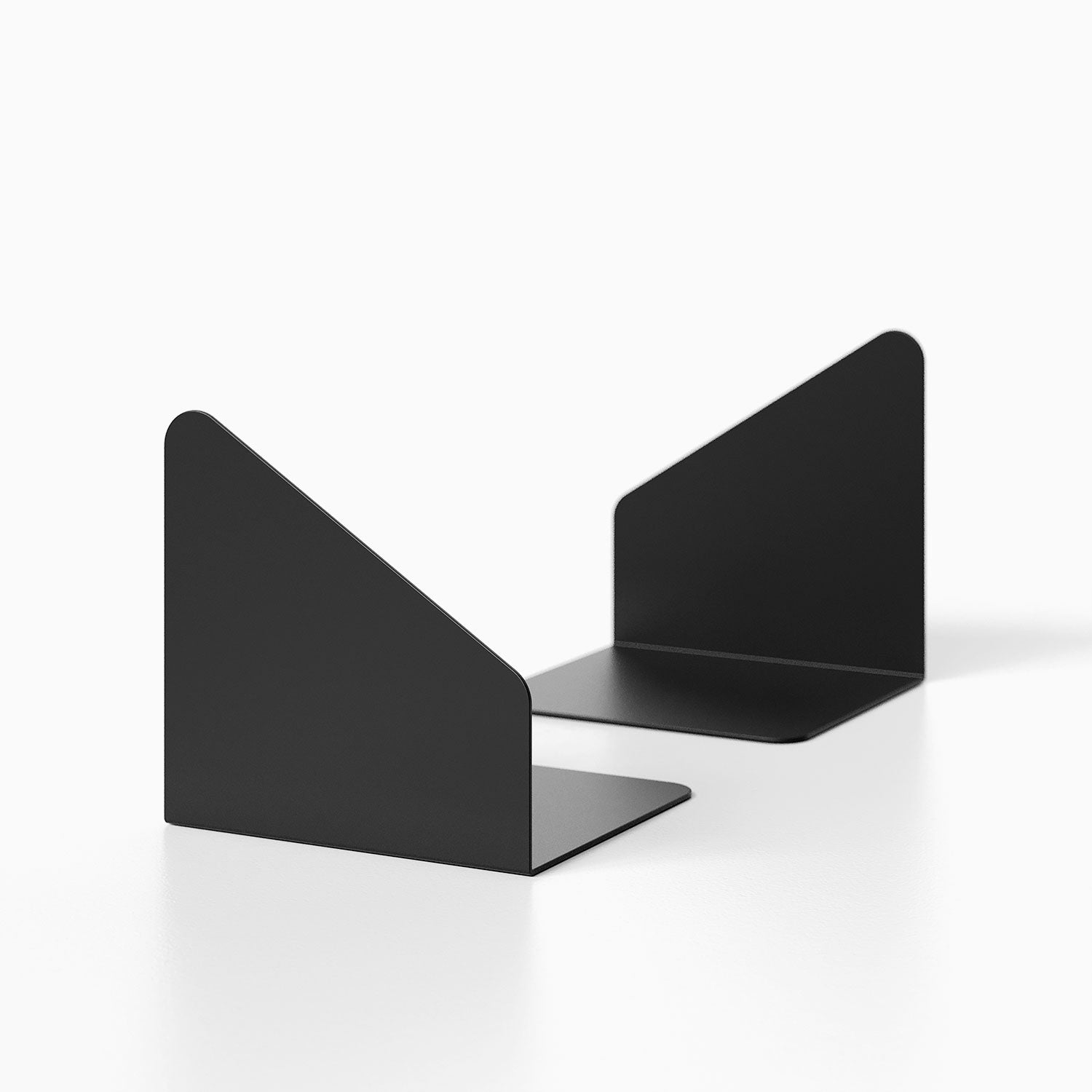 Geo Angle Bookend (Set of Two) in matte black metal with minimalist geometric design, ideal for organizing books on shelves or desks.