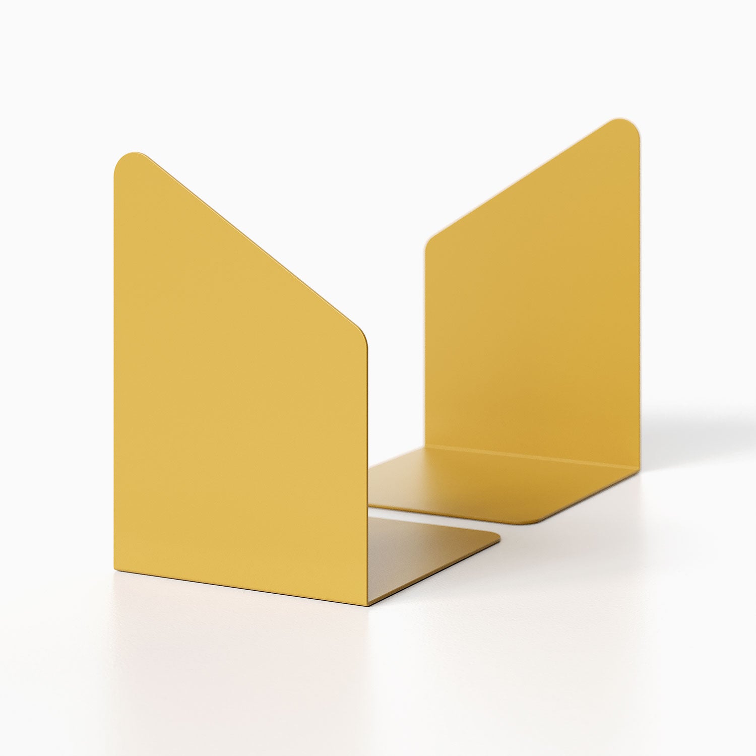 Geo Angle Bookend (Set of Two) in mustard yellow steel with a minimalist geometric design for organizing books and display ledges.