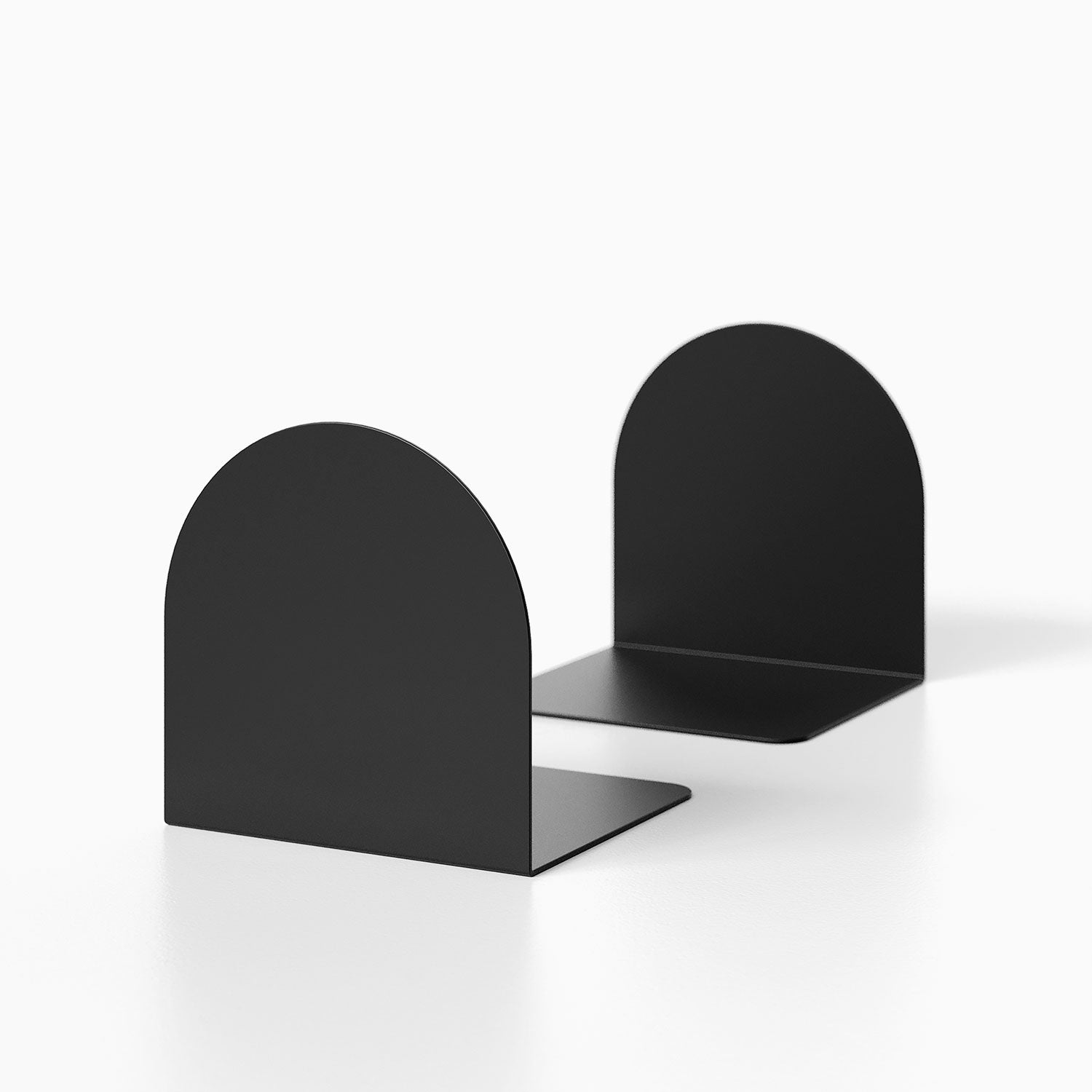 Geo Round Bookend (Set of Two) in matte black metal with minimalist rounded design, perfect for organizing books on shelves or desks.