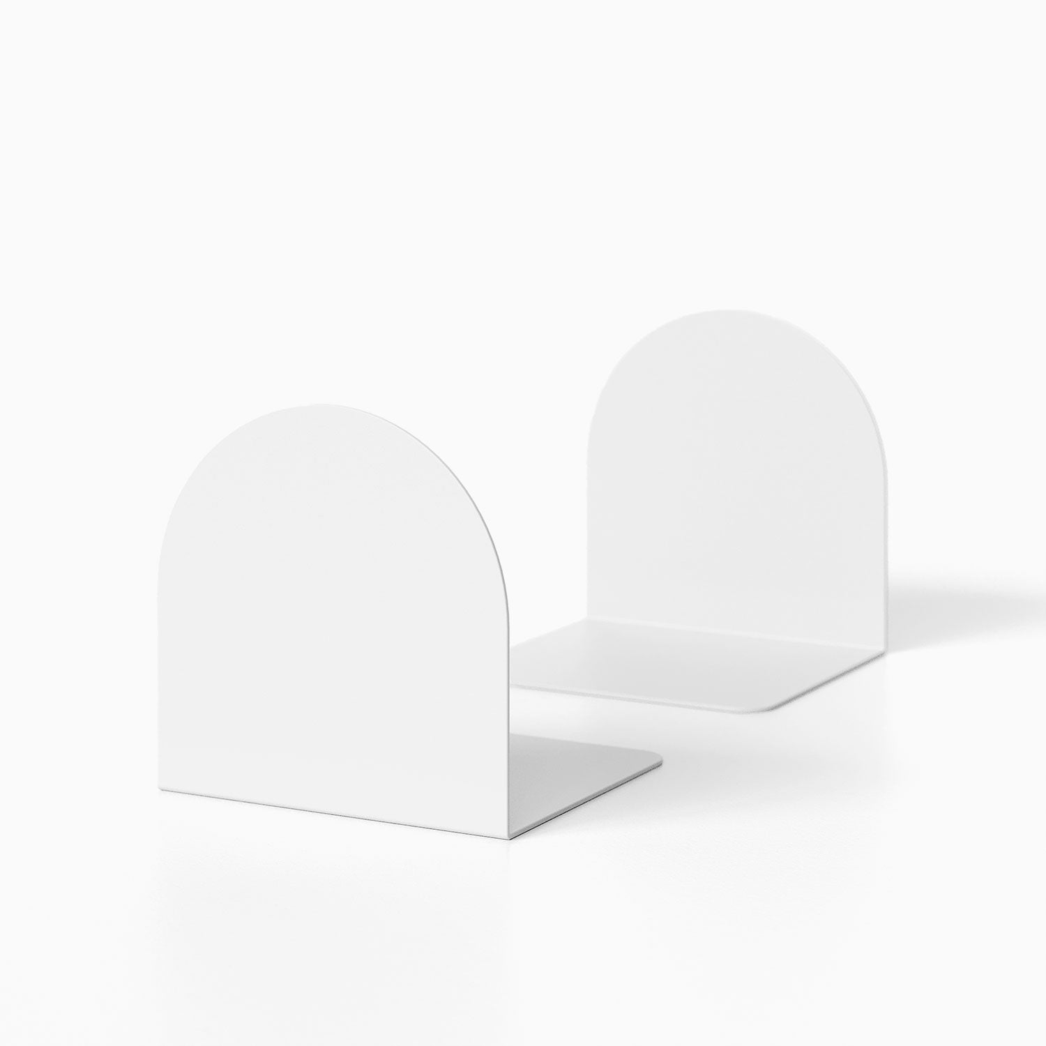 Geo Round Bookend (Set of Two) in minimalist white metal with a smooth rounded design, ideal for organized wall shelves and display ledges.
