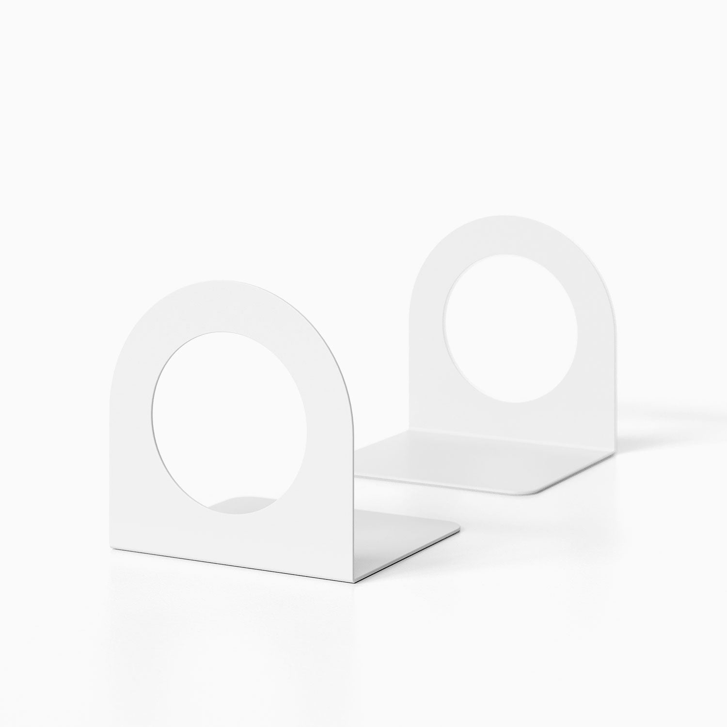 Minimalist white metal Geo Round Open Bookend (Set of Two) with circular cutouts, designed for functional wall shelf and display organization.