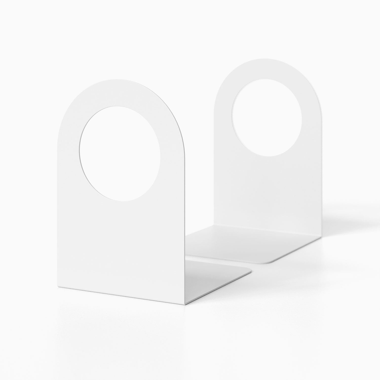 Minimalist white metal Geo Round Open Bookend (Set of Two) with circular cutouts, designed for functional and stylish book organization.