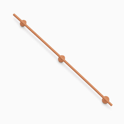 Minimalist wood Grip Stair Rail with smooth cylindrical design and round wall mounts, perfect for functional and stylish wall shelf support.