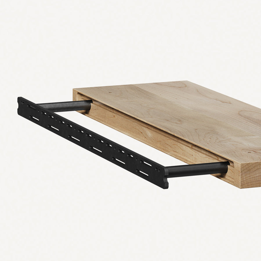 Rear view of a floating shelf sliding onto the steel rods of a concealed floating shelf bracket