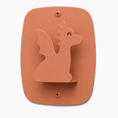 Kiddo Hooks in rust-colored clay with a dragon silhouette design, made from durable material to organize kids' rooms with playful wall hooks.