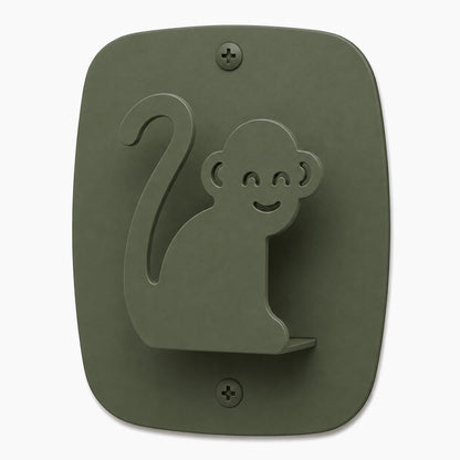 Kiddo Hooks wall hook shaped like a smiling monkey in muted green, made from durable rust-resistant stainless steel for organized, playful spaces