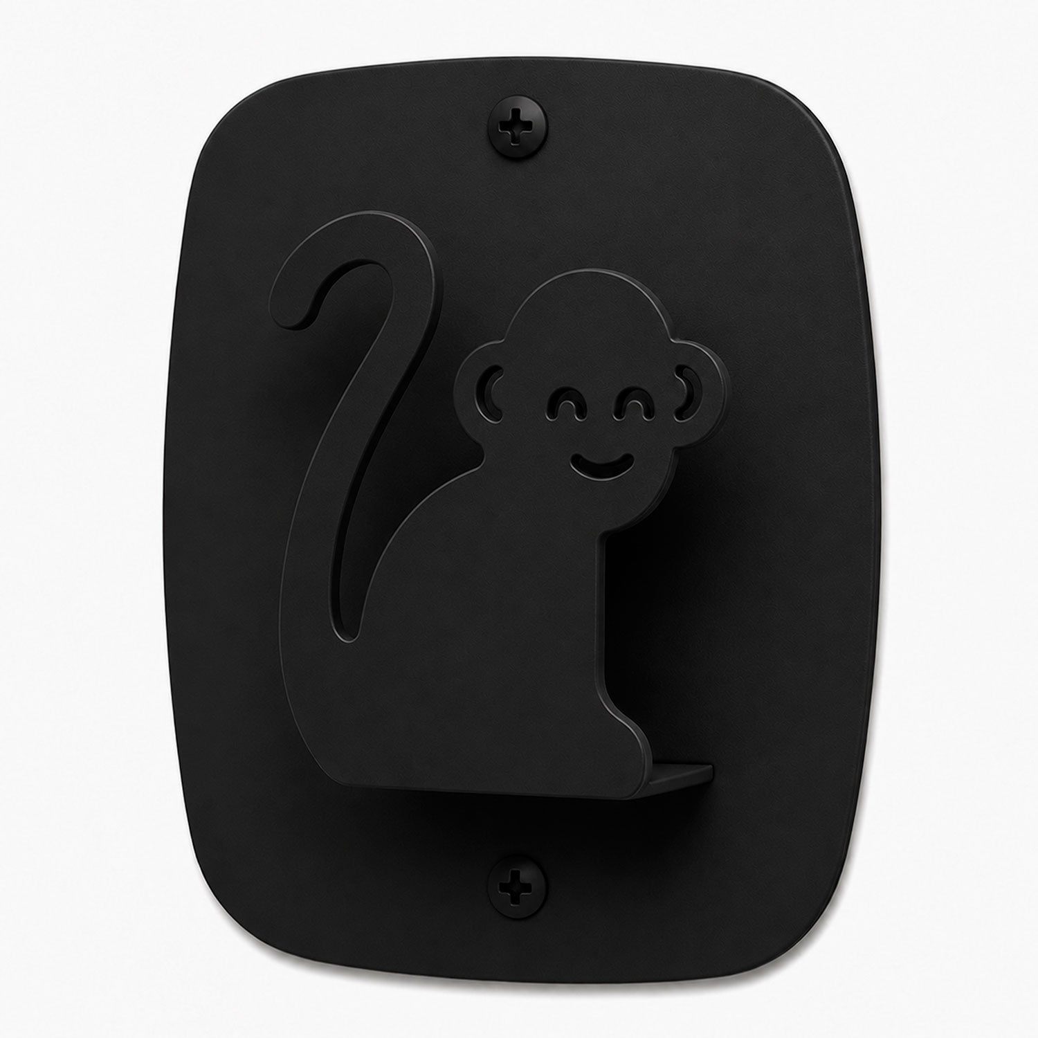 Kiddo Hooks in black metal shaped like a smiling monkey mounted on a flat wall plate, designed for functional wall organization.