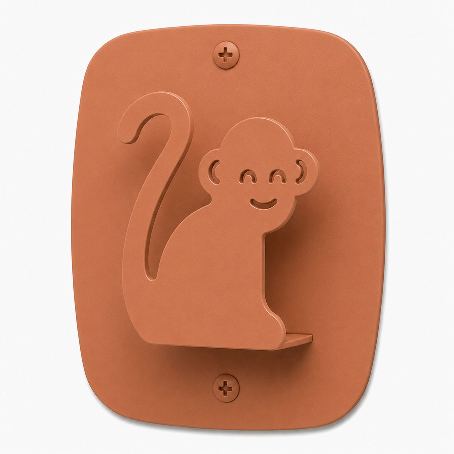 Minimalist wall hook shaped like a smiling monkey in warm clay color, designed for organization and display with Kiddo Hooks.