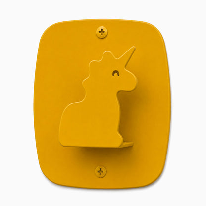 Kiddo Hooks in honey mustard color shaped like a playful unicorn silhouette, made with durable materials for organizing children's spaces.