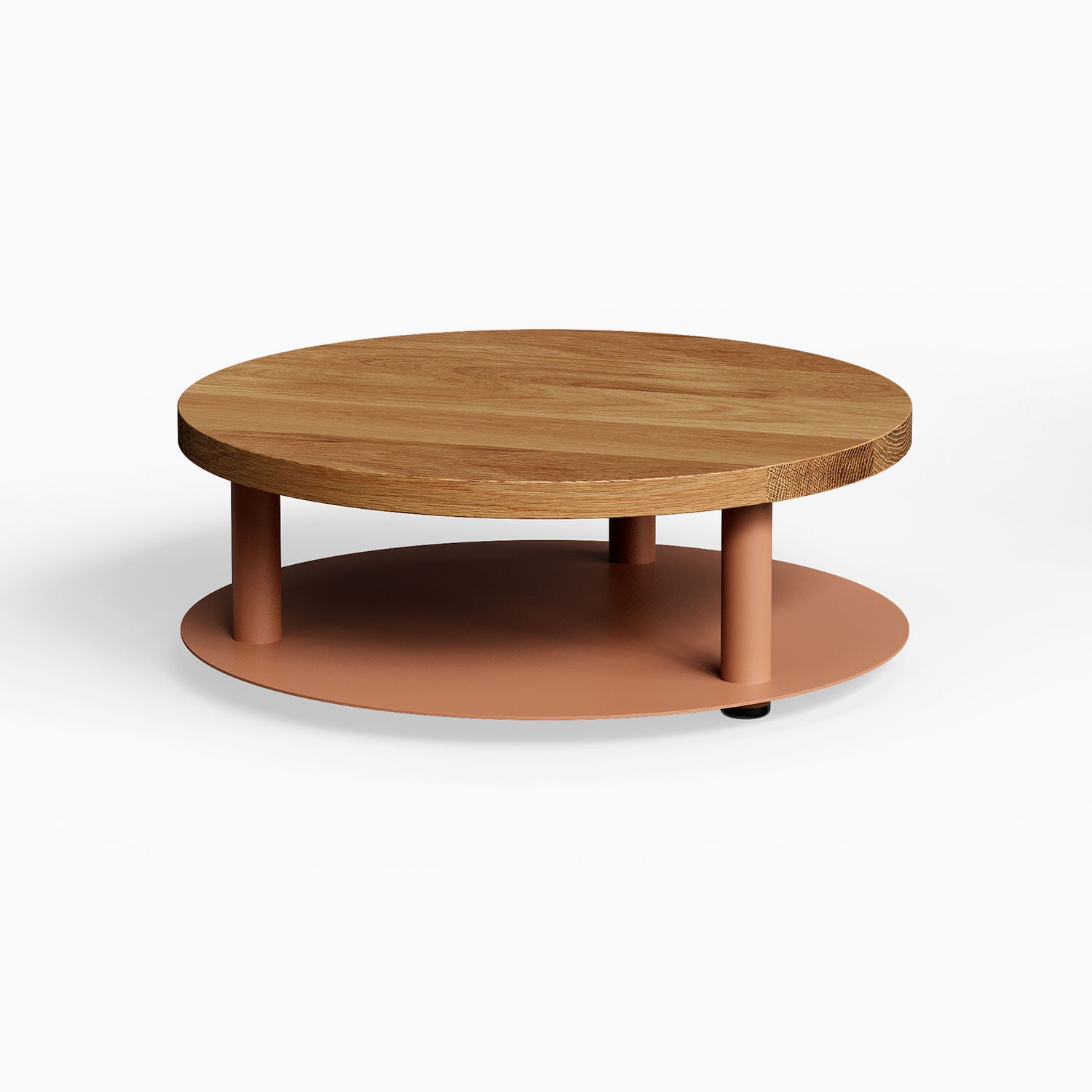 Ledger Coffee Table with a round solid hardwood top and a matte clay-colored metal lower shelf, combining wood and steel for modern minimalist style.