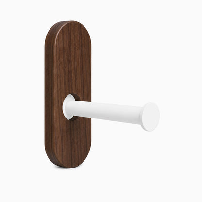 Lou Toilet Paper Holder with a walnut solid hardwood backplate and rust-resistant white steel arm designed for minimalist, functional wall organization.