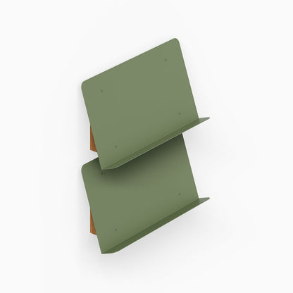 The Edit Book +Magazine Display features two angled olive green shelves with a minimalist design perfect for organizing and displaying books and magazines.