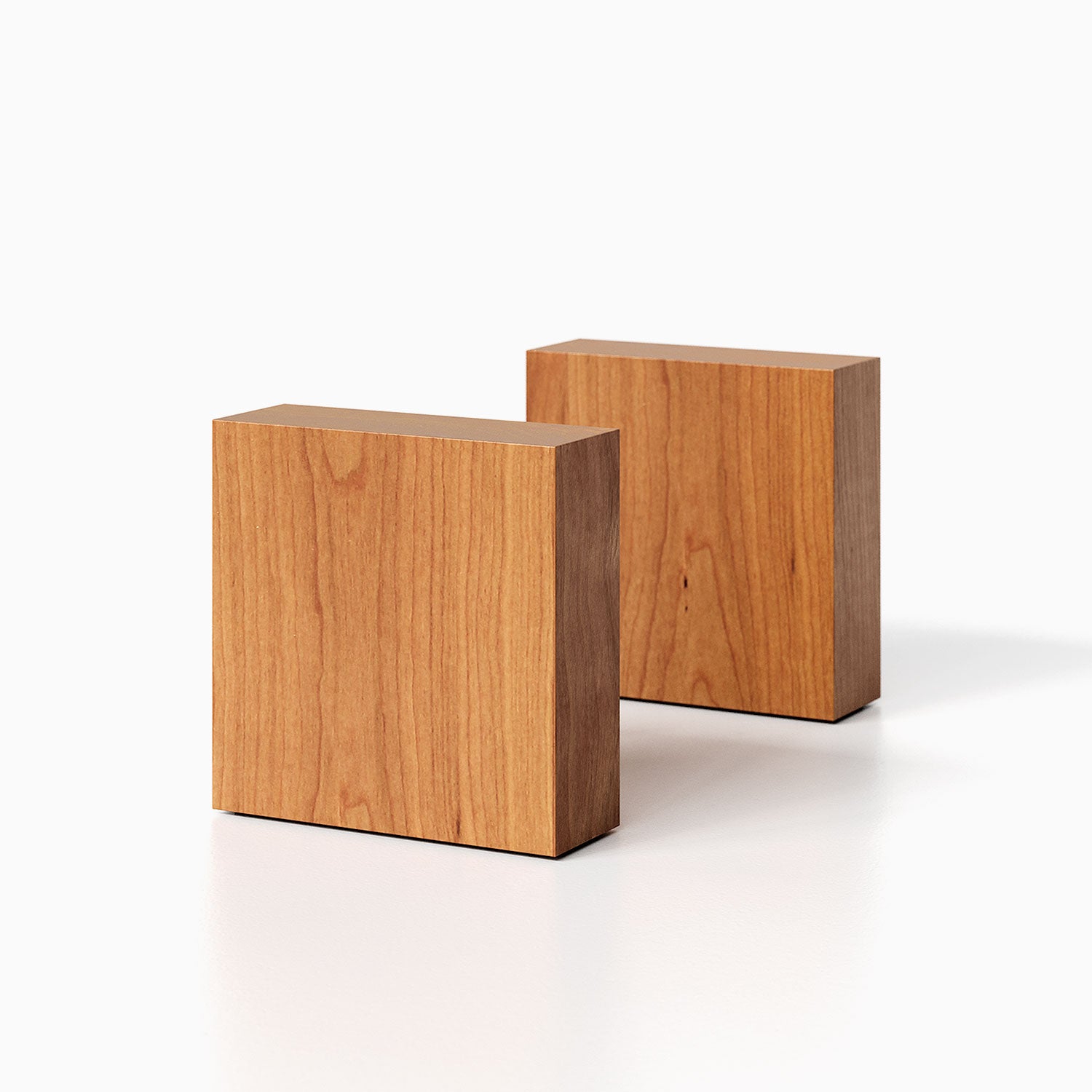 The Maggie Square Product (cherry finish) pictured against a white background. Two bookends positioned in the center, one slightly off center, in front of the other.