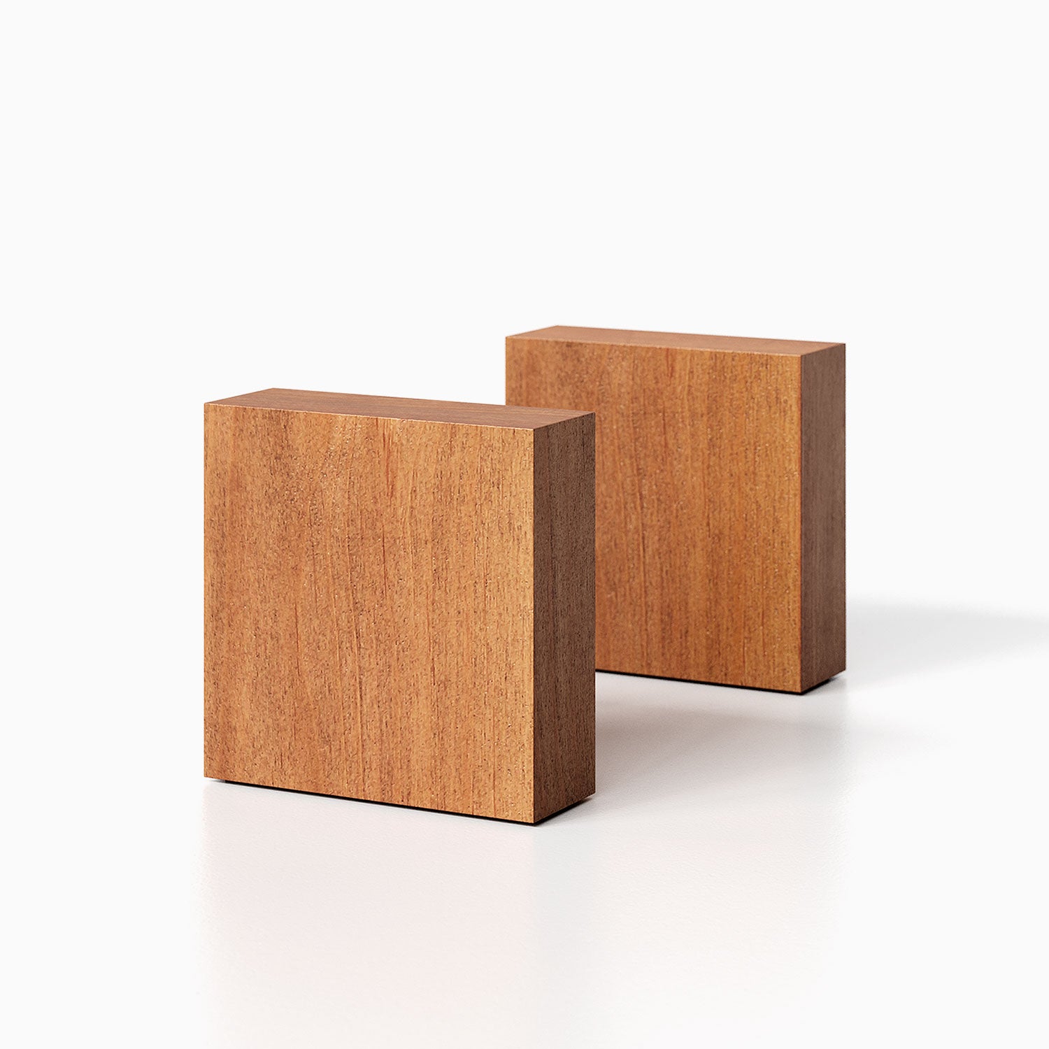 The Maggie Square Product (nutmeg finish) pictured against a white background. Two bookends positioned in the center, one slightly off center, in front of the other.