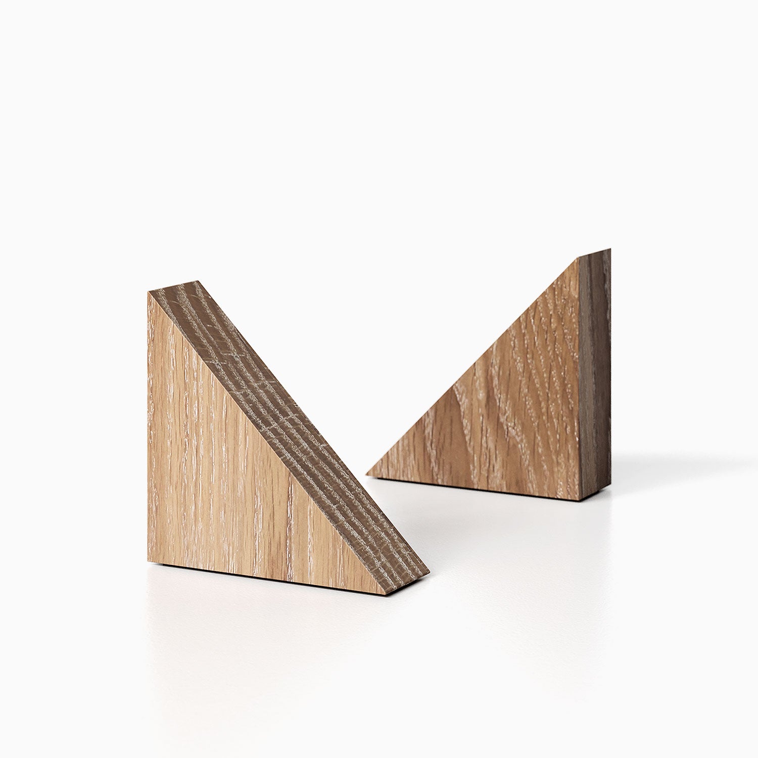 The Maggie triangle Product (white oak glazed finish) pictured against a white background. Two bookends positioned in the center, one slightly off center, in front of the other.