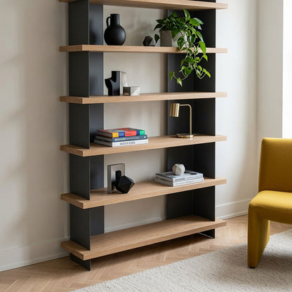 Modern Nigel Bookshelf with natural wood shelves and black steel supports, styled with books, decor, and a plant in a minimalist room.