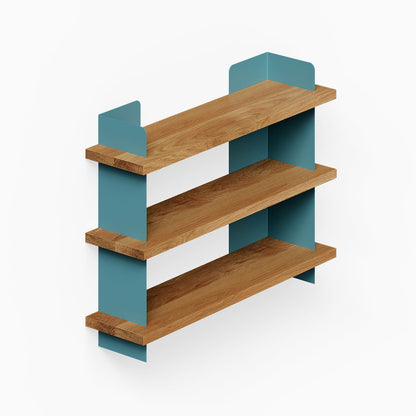 Nigel Bookshelf with three solid hardwood shelves supported by blue steel brackets, blending wood and metal for a modern wall display.