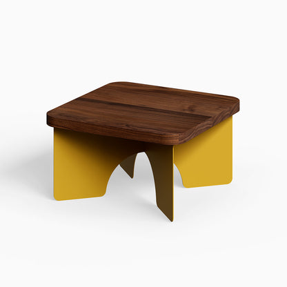 Ledger Coffee Table with solid walnut wood top and mustard yellow steel base, showcasing minimalist mixed-material design for functional spaces.